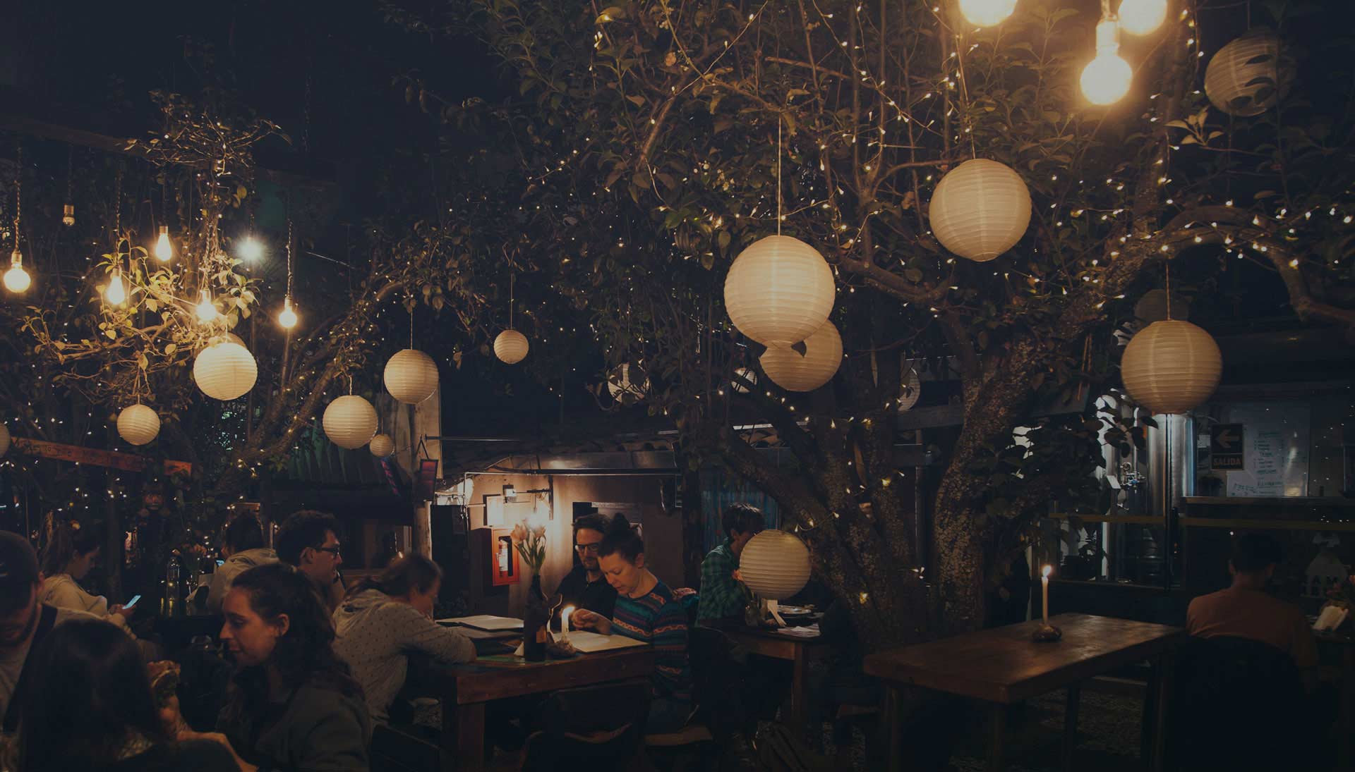 People dining at Green Point Restaurants inner garden during the night.